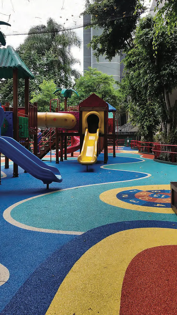 Children's play area with slides on colourful rubber flooring