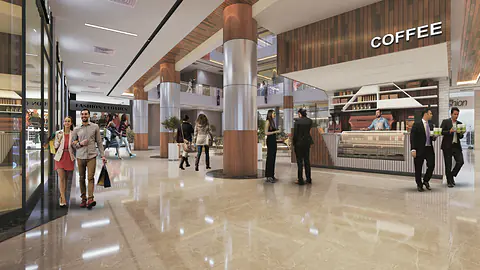 Mall concourse with polished marble floor, timber-clad columns and a coffee counter